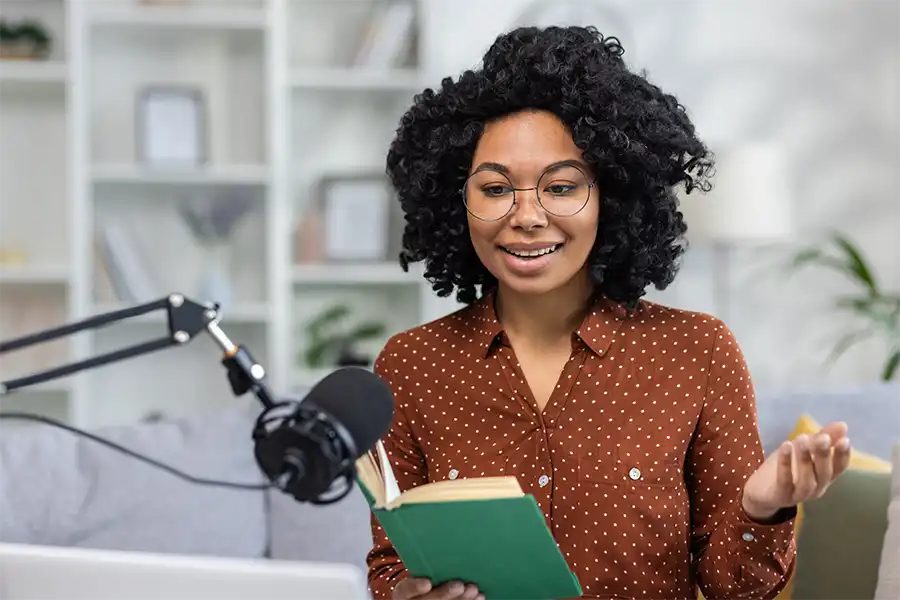 A young woman reading her book during a live stream on social media