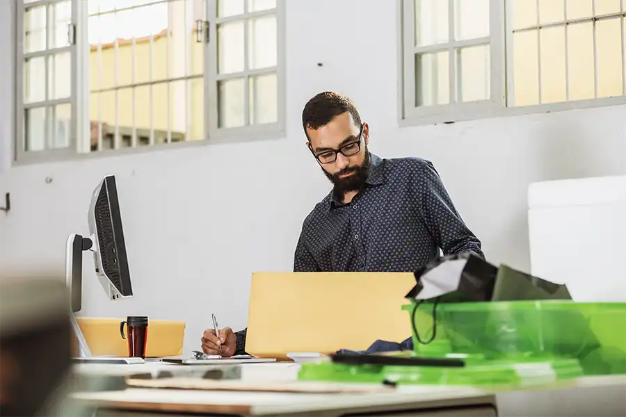 Middle-aged man sitting at a desk preparing a press kit for his upcoming book.
